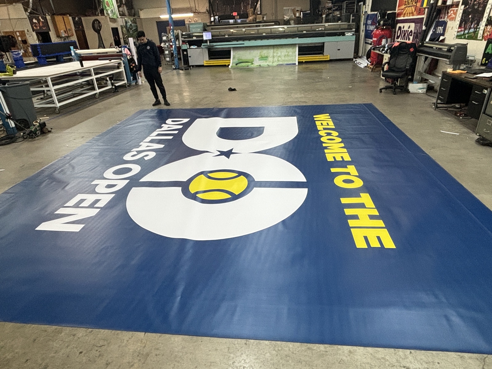 Employee working beside an oversized printed graphic