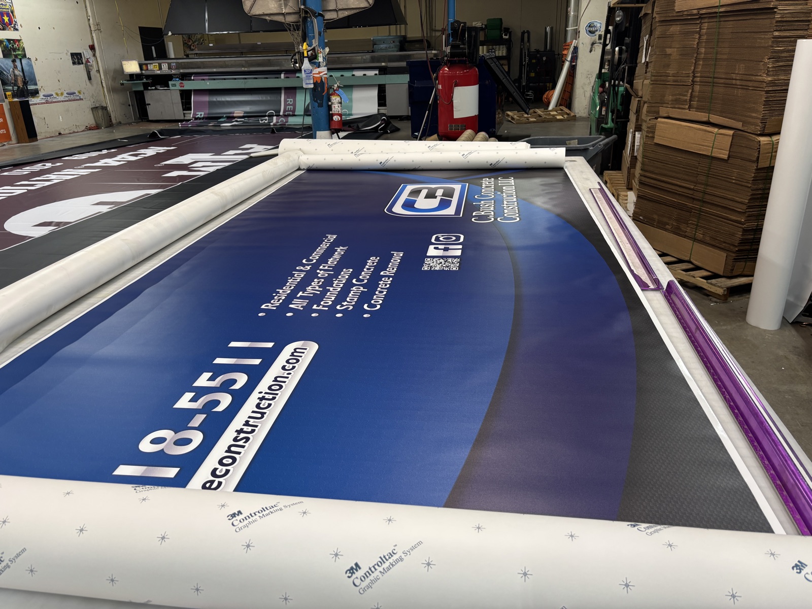 Large-format printed material being finished in production